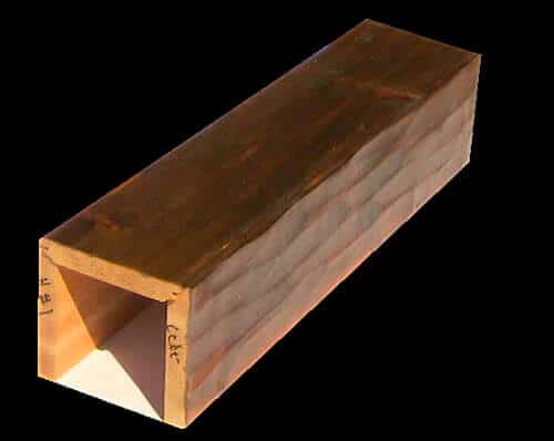 A sample of a decorative, custom made ceiling beam, a 3 sided hollow beam known as a box beam, sample shown handmade out of real cedar wood